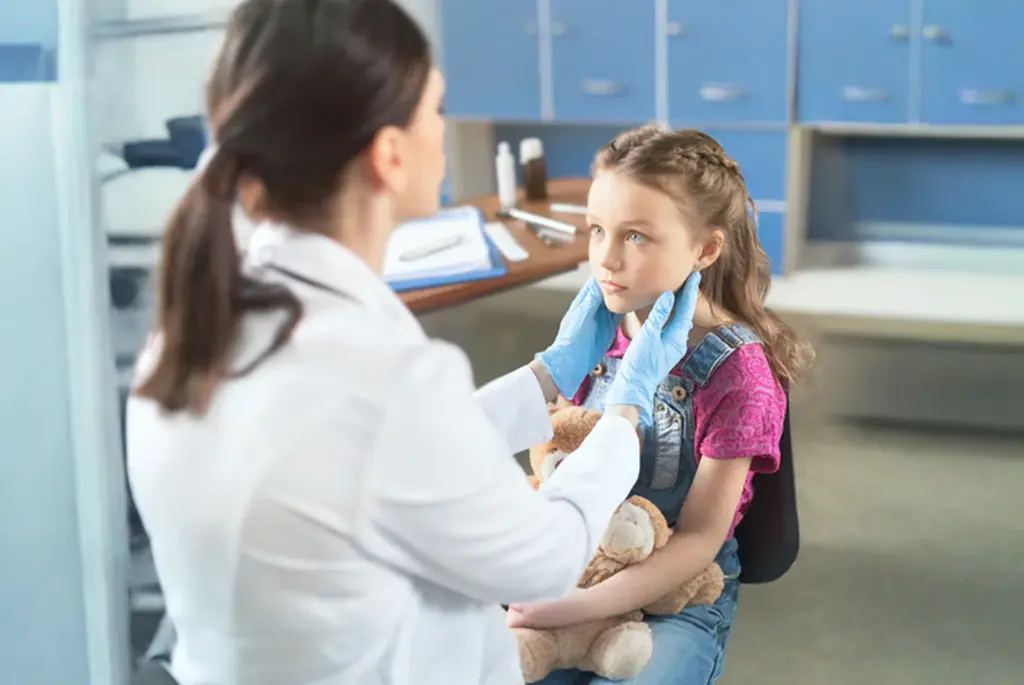 Pharmacist taking a look at a child. Minor Ailment Scheme in Huddersfield at Park View Pharmacy.